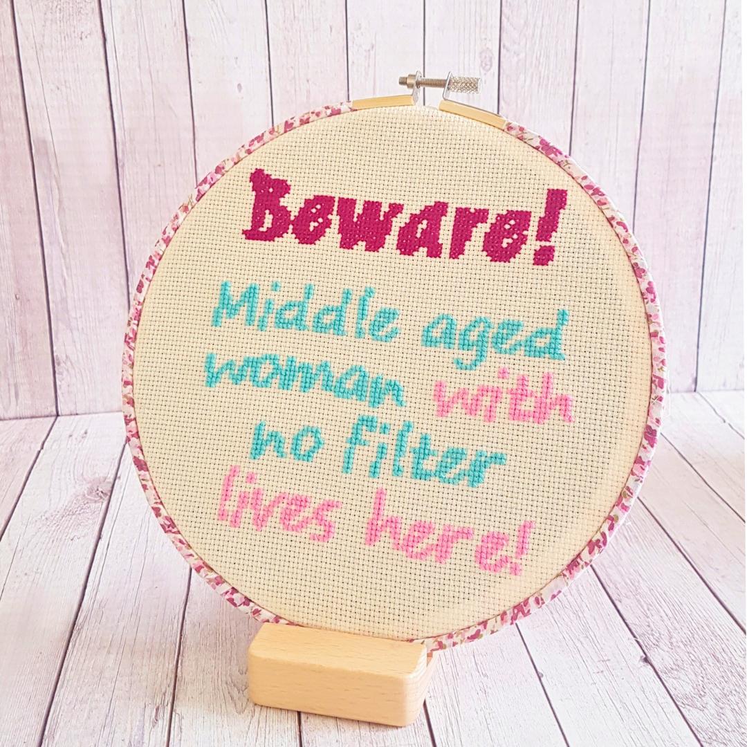 Completed cross stitch 'Beware! Middle aged woman with no filter lives here!'