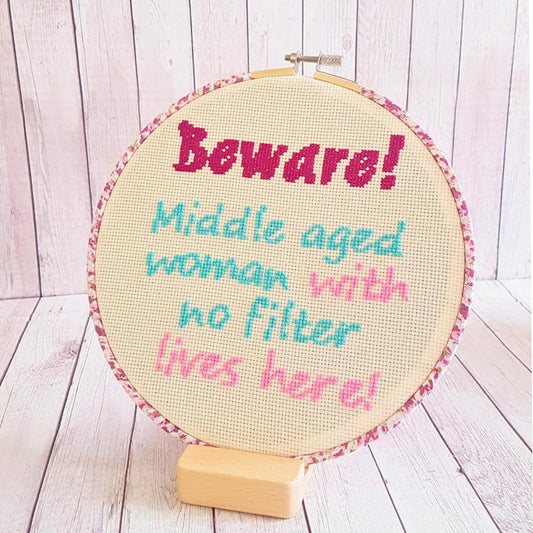 Completed cross stitch 'Beware! Middle aged woman with no filter lives here!'
