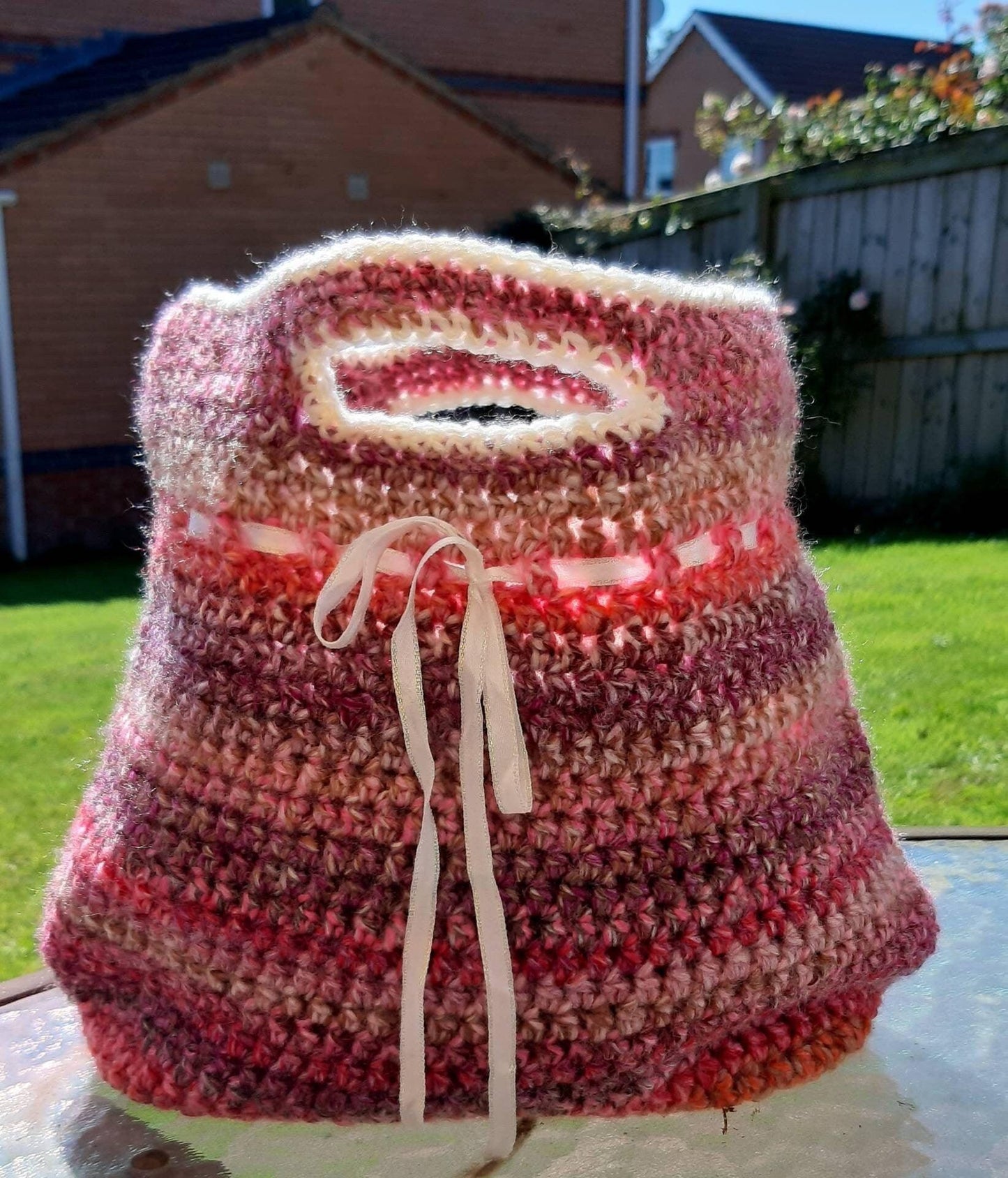 Handmade crochet handbag in mixed pink yarn