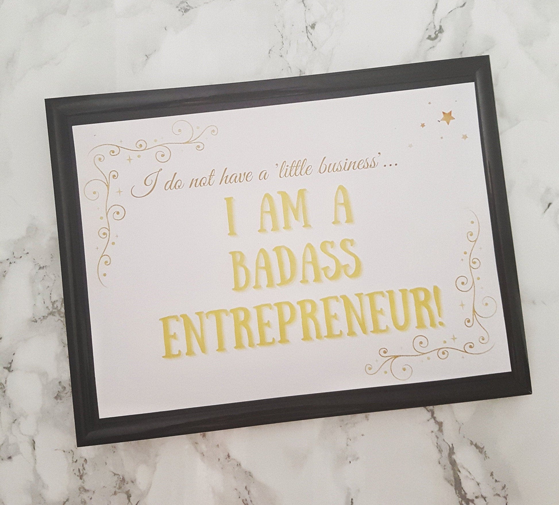 Inspirational quote for female small business owners 'I am a badass entrepreneur' printed on card and displayed in black frame for demonstration purposes