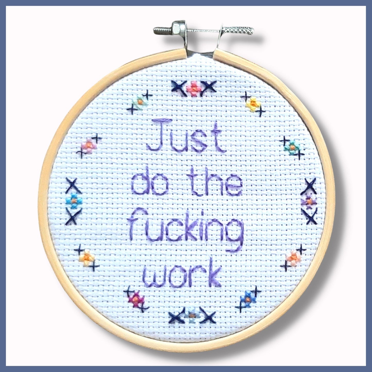 4 inch hoop from Thistleflat Crafts with embroidered quote 'Just do the fucking work' in purple thread with flower border