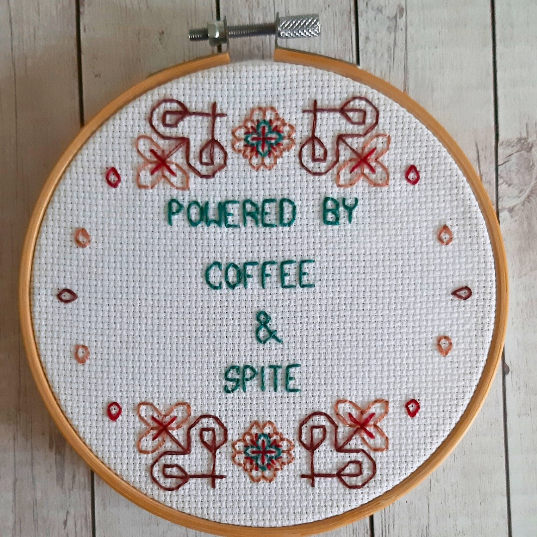 Powered by coffee and spite, completed cross stitch quote - Thistleflat Crafts