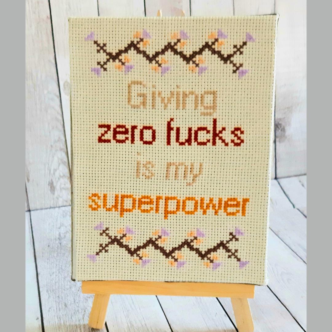 Giving zero fucks is my superpower, completed cross stitch quote - Thistleflat Crafts