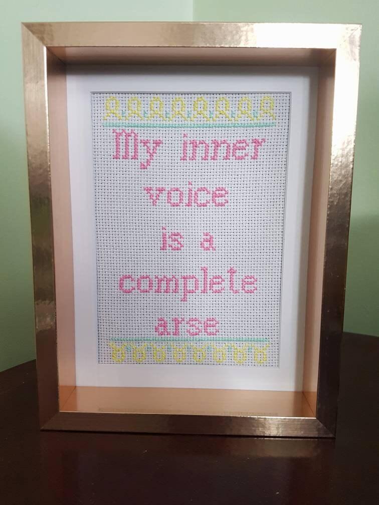 Completed cross stitch quote by Thistleflat Crafts. 'My inner voice is a complete arse' in rose gold chunky frame